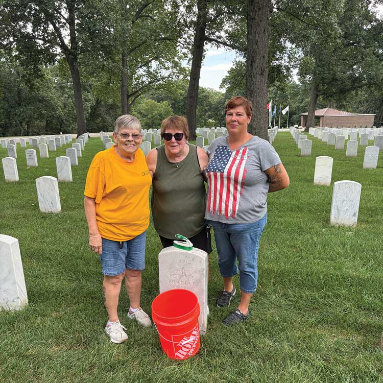 members helping clean gravestones 